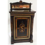 A VICTORIAN EBONISED MUSIC CABINET with mirror back and inlay of a bird on a branch, the cabinet