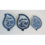 THREE CHINESE EXPORT BLUE AND WHITE LEAF DISHES painted with island villages, sampans and mountains,