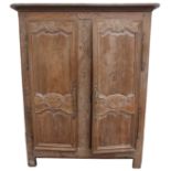 A 19TH CENTURY FRENCH OAK ARMOIRE the doors having carved floral panels with an upper and centre