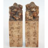 A PAIR OF CHINESE SOAPSTONE SEALS each carved with a shishi and cubs astride pillars with