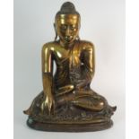 AN INDIAN BRASS MODEL OF BUDDHA seated in lotus position and hand touching earth to witness, 55cm