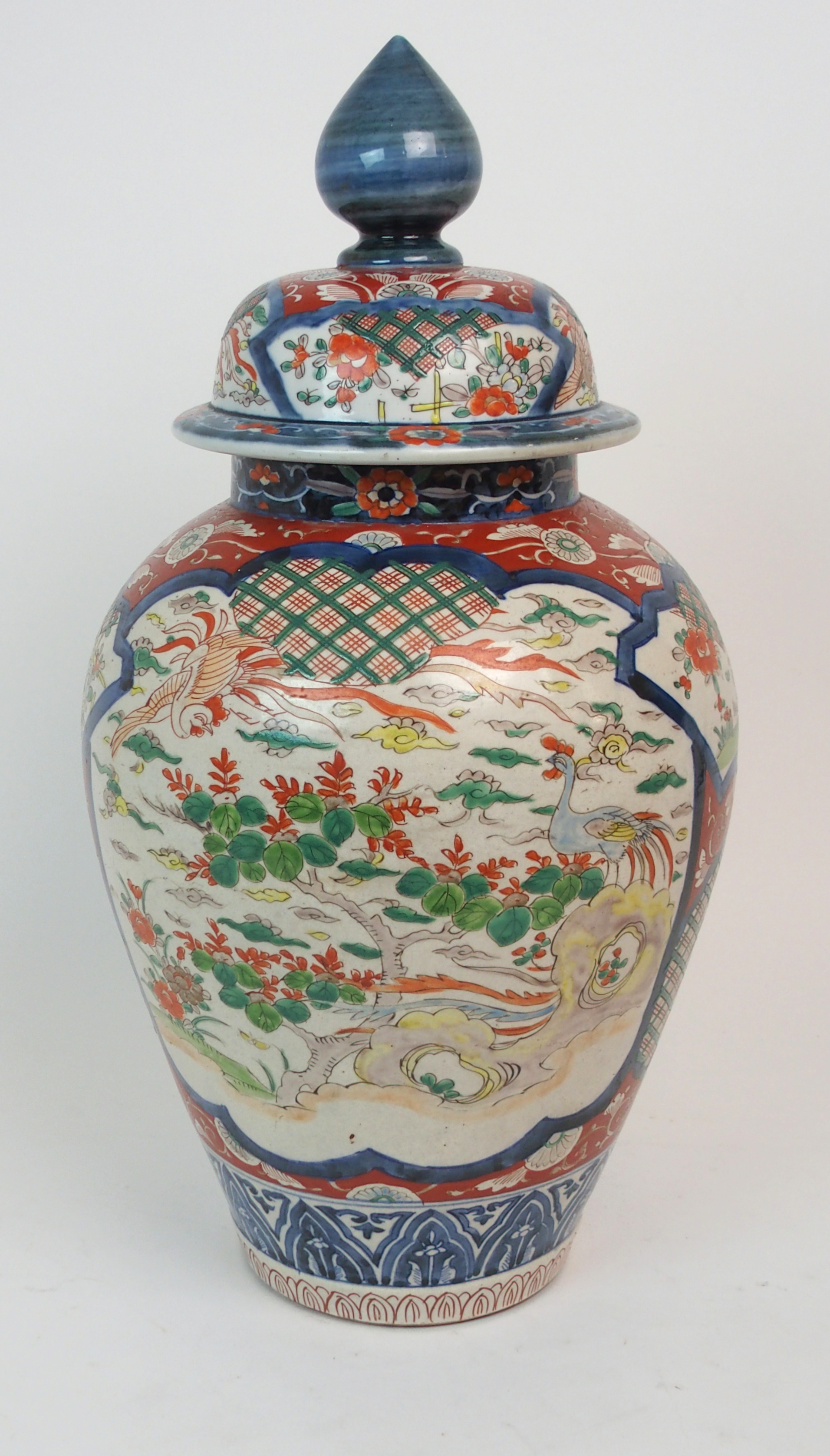 A JAPANESE IMARI BALUSTER VASE AND COVER painted with Ho-o birds, foliage and diaper within framed