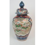A JAPANESE IMARI BALUSTER VASE AND COVER painted with Ho-o birds, foliage and diaper within framed