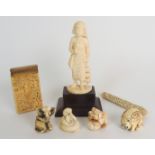 A CHINESE IVORY CARD CASE carved all over with figures amongst balconies and trees, later brass