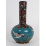 A CLOISONNE BALUSTER VASE decorated with cranes beneath foliate mosaic patterns, 22cm high Condition
