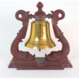 A VICTORIAN BRASS SHIP'S BELL unnamed, on cast iron stand, modelled as twin mythological