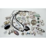 A collection of silver and white metal jewellery to include brooches pendants gem set earrings etc