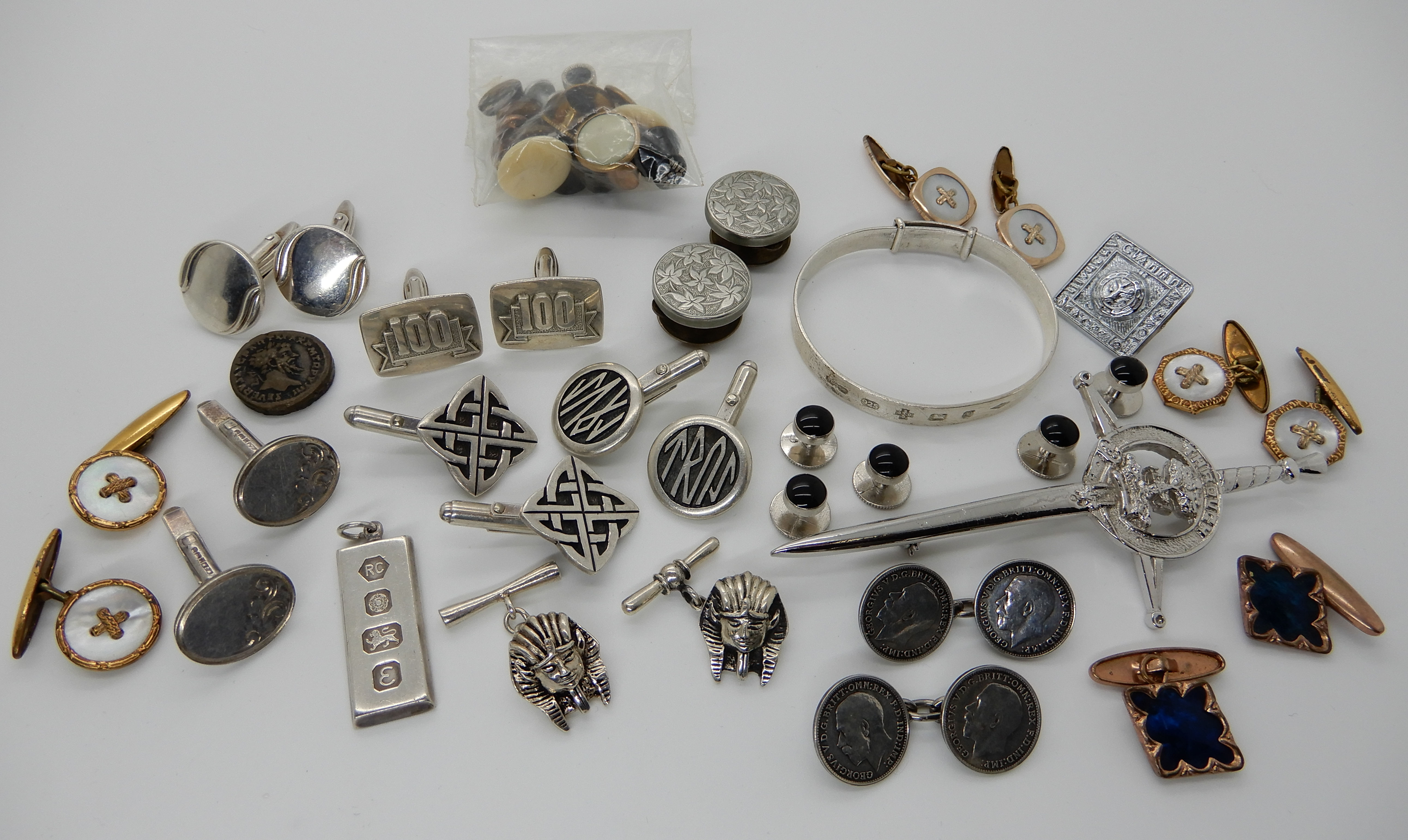 A silver bangle, a collection of silver and costume jewellery cufflinks etc Condition Report: Not