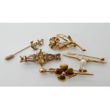 A 9ct gold flower brooch, 9ct yellow gem set brooch, 9ct pearl brooch, 9ct anchor pin and a bright