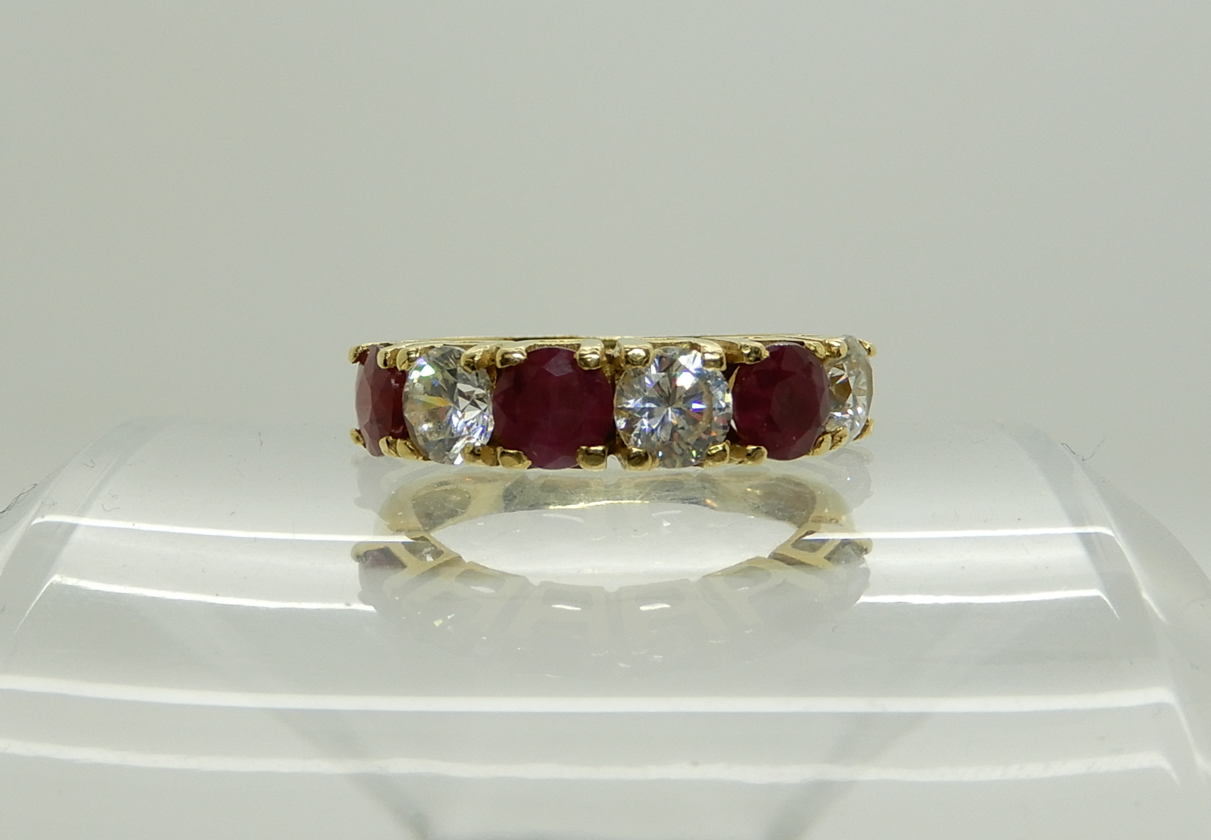 A continental bright yellow metal ruby and clear gem ring, size P, weight 5gms Condition Report: