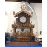 A gingerbread clock under glass dome Condition Report: The dome is broken.