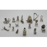 A lot comprising seventeen assorted miniature white metal items - chair, harp, candleholder, boats