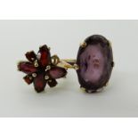 A 9ct gold garnet flower ring, size N (one garnet missing), a 9ct purple glass set ring, size T,