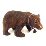 A Black Forest carved bear, 21cm long Condition Report: Has crack running up his hind leg.