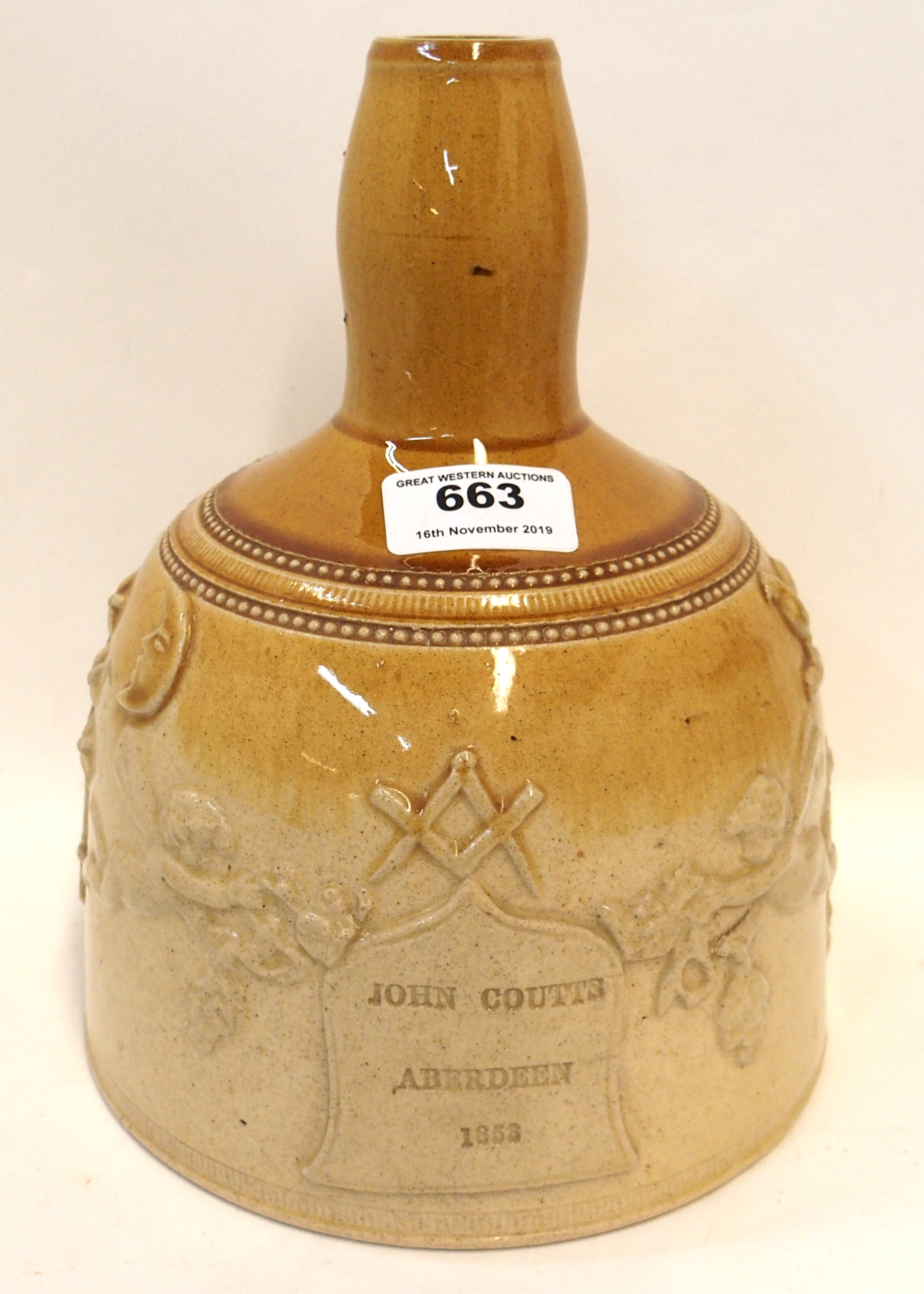 A Mason's Mallet whisky decanter in brown and tan glaze with raised Masonic symbols with central