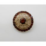 A 9ct gold garnet set brooch, diameter 2.7cm, weight 5.7gms Condition Report: Available upon