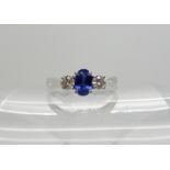 An 18ct white gold sapphire and diamond three stone ring, diamonds estimated approx combined 0.