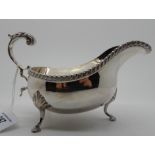 A silver sauceboat by Mappin & Webb, Sheffield 1973 with gadrooned border and open scrolling