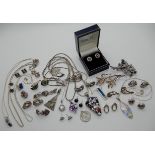 A collection of silver and white metal jewellery, many gem set, with fancy chains Condition