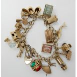 A 9ct gold charm bracelet with heart shaped clasp and seventeen 9ct gold and yellow metal charms