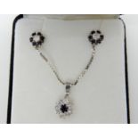 An 18ct white gold diamond and sapphire flower pendant with matching earrings, estimated approx