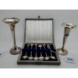 A lot comprising a cased set of six novelty white metal coffee spoons and two silver vases,