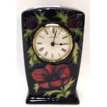 A Moorcroft anemone pattern clock, 16cm high Condition Report: Available upon request