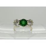 An 18ct emerald and diamond three stone ring, set with estimated approx 1.20cts combined, the