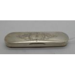 A white metal box, unmarked, of rectangular form with rounded ends, engraved decoration with