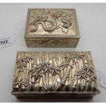 A lot comprising an oriental white metal dragon decorated box and another with bamboo decoration,