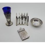 A lot comprising a silver toastrack, Birmingham 1938, a silver vase, London 1904, a white metal dish