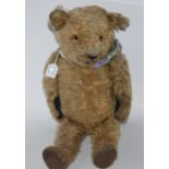 A vintage possibly Merrythought centre-seam Teddy bear 60cm long, rabbit soft toy and dog soft