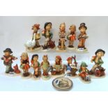 Thirteen Hummel figures including Goose Girl, Strolling along, Band Leader, Puppy Love etc Condition