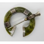 An Iona/Connemara green marble pen annular brooch with thistle shaped pin and white metal finials