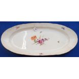 A large continental oval platter with painted floral decoration, 63cm long Condition Report: