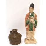 A terracotta figure of a man together with a brown glazed stoneware vessel Condition Report: