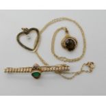 A 9ct gold smoky quartz pendant and chain, a diamond accent set heart pendant and a yellow metal