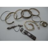 A collection of silver and white metal bangles, a bracelet and two needle cases Condition Report: