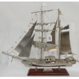 A white metal model of a two masted sailing ship, Zebu Brigantime on wooden stand, 53cm long x 49.