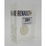 A Renault advertising desk weight, a 1961 US half dollar encased in a perspex block Condition