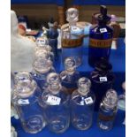 A collection of Chemist bottles including two blue examples one with label and eight clear examples,