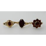 A 9ct gold garnet flower cluster ring size P1/2 and two others combined, weight 5.9gms Condition
