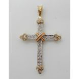 An 18ct yellow, white and rose gold diamond set cross, set with estimated approx 0.50cts of