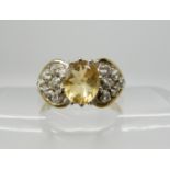A 9ct citrine and diamond dress ring size O1/2, weight 3.3gms Condition Report: Available upon
