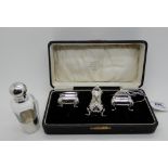 A lot comprising a cased three piece silver condiment set, Birmingham 1923 and a silver mounted