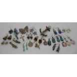 A white metal Scottish agate anchor brooch, and a collection of silver and white metal earrings,