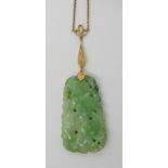 A 9ct gold mounted jade pendant, carved with fruit to both sides, length of the hardstone approx 4cm