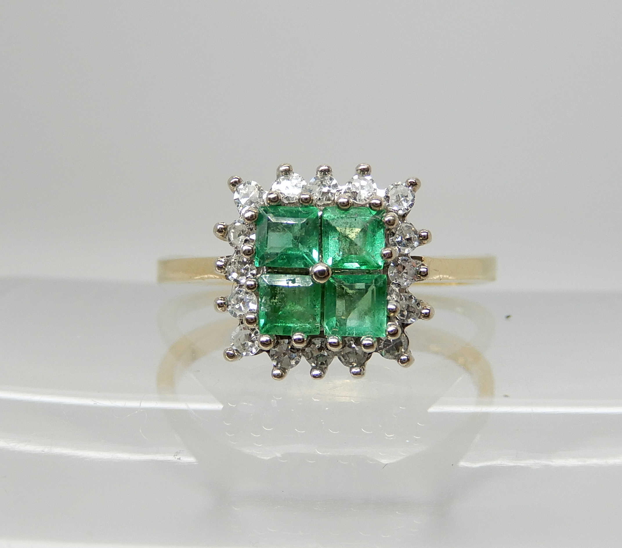 An 18ct gold four square emerald and diamond cluster ring, size O1/2, weight 3.3gms Condition