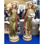 A pair of Royal Dux figures of water carriers Condition Report: The female figure is badly cracked.