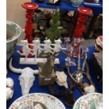 A pair of red candle stands, dancing cow ornament, glass candelabra, stags head ornament and